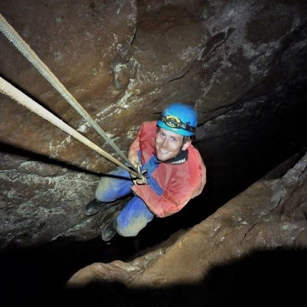 Mine explorer climbing a mineshaft near St. Just, Cornwall