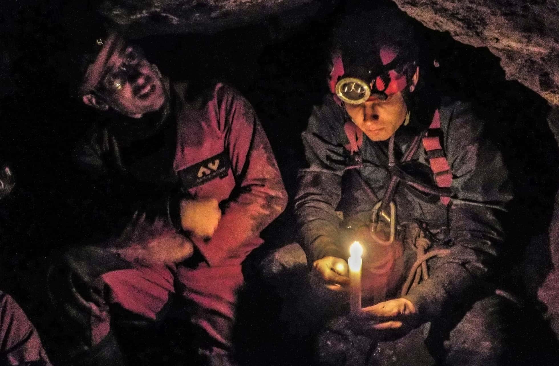 Mine explorers in a Cornish tin mine experiencing candlelight, just like the miners of old.