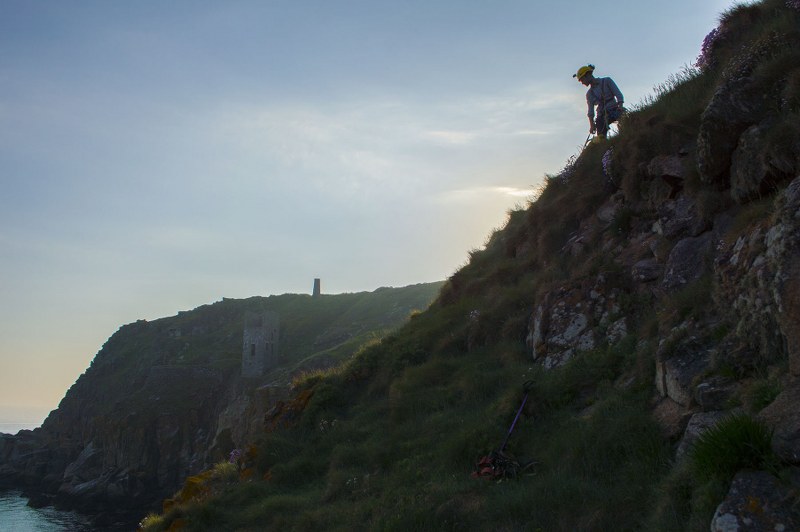 Cornwall Underground Adventures guide on the cliffs, searching for mine history and mining archaeology.