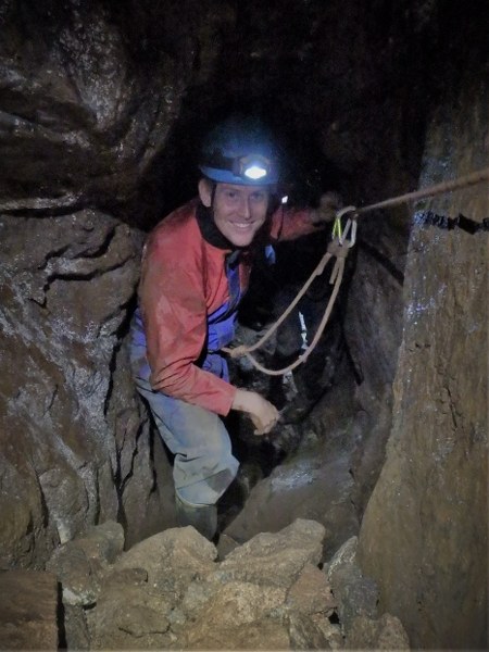 Mine explorer traversing a deep mine shaft near St. Ives, Cornwall.