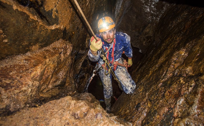 Mine Explorer wearing overalls instead of a caving suit in a Cornish mine