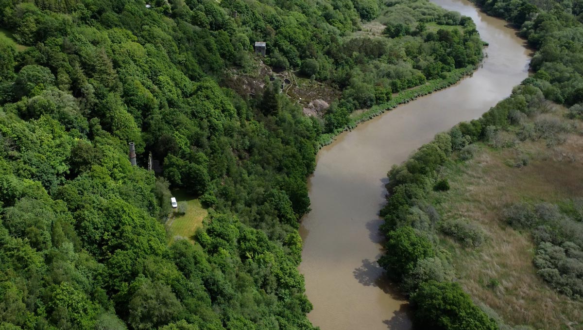 Okel Tor Mine on the banks of the Tamar River in Cornwall. Drone photo by Cornwall Underground Adventures