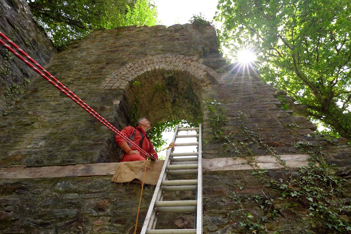 Rigging ropes going through the window of an old Cornish engine house. Photo by Cornwall Underground Adventures