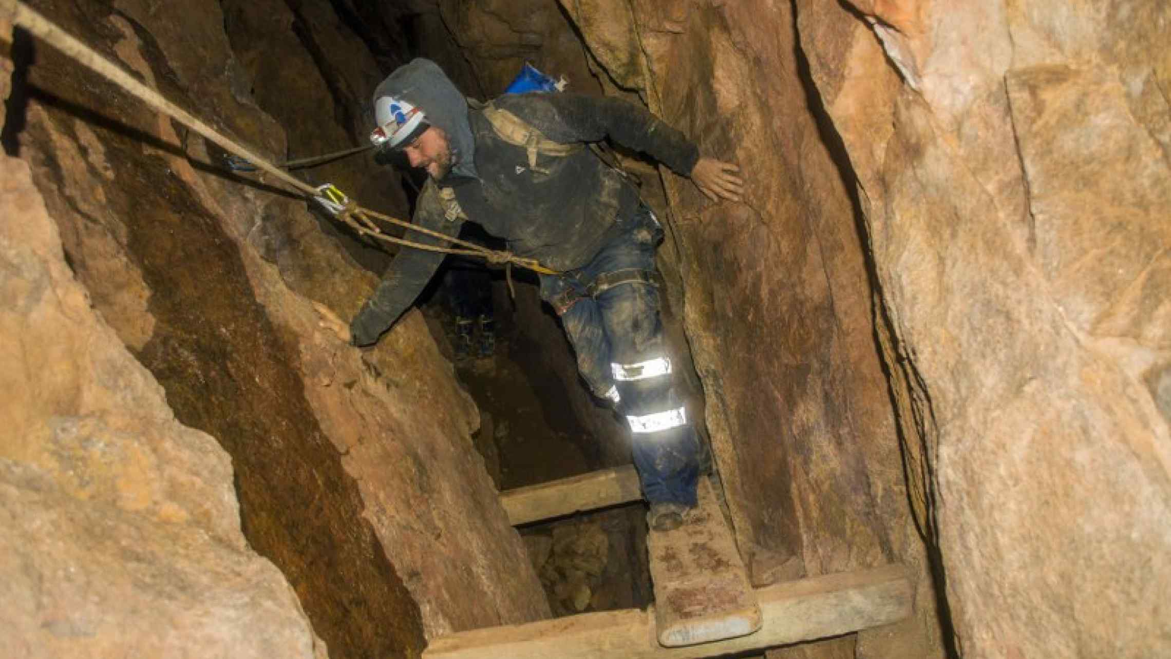 Mine explorer using ropes to cross deep mine shafts. Top adventure in a Cornish tin mine. Mine tours available across Cornwall, near St. Just, St. Ives, Penzance, Newquay, Falmouth and Helston.