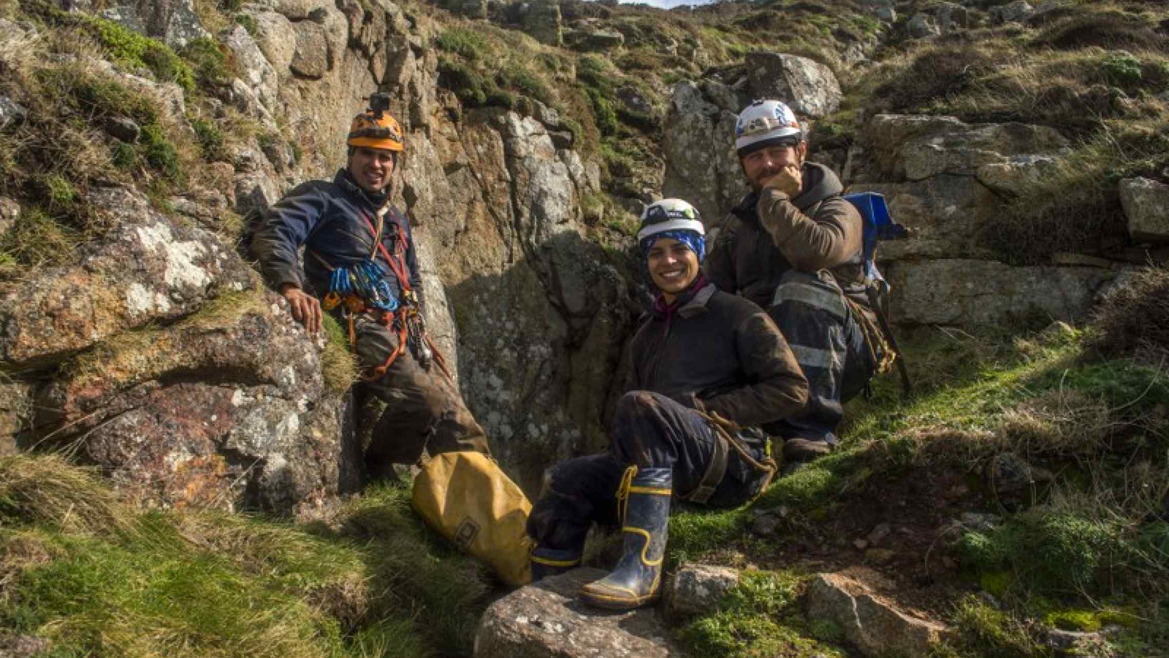 Mine explorers posing near the entrance to a Cornish tin mine, after their trip with Cornwall Underground Adventures.