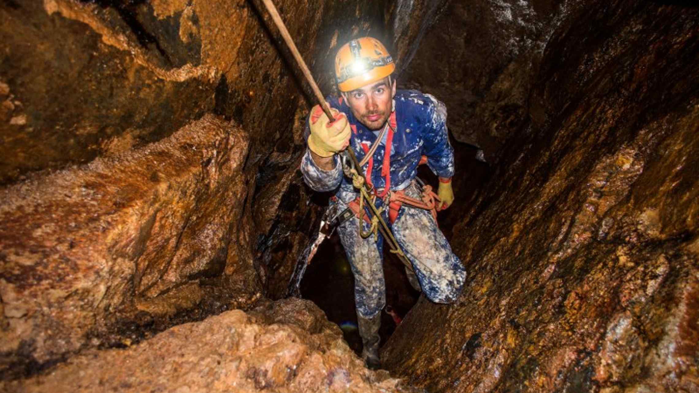 Mine explorer in Cornwall abseiling down a mine shaft. Adventure Newquay, things to do in St. Ives, underground mine tours.