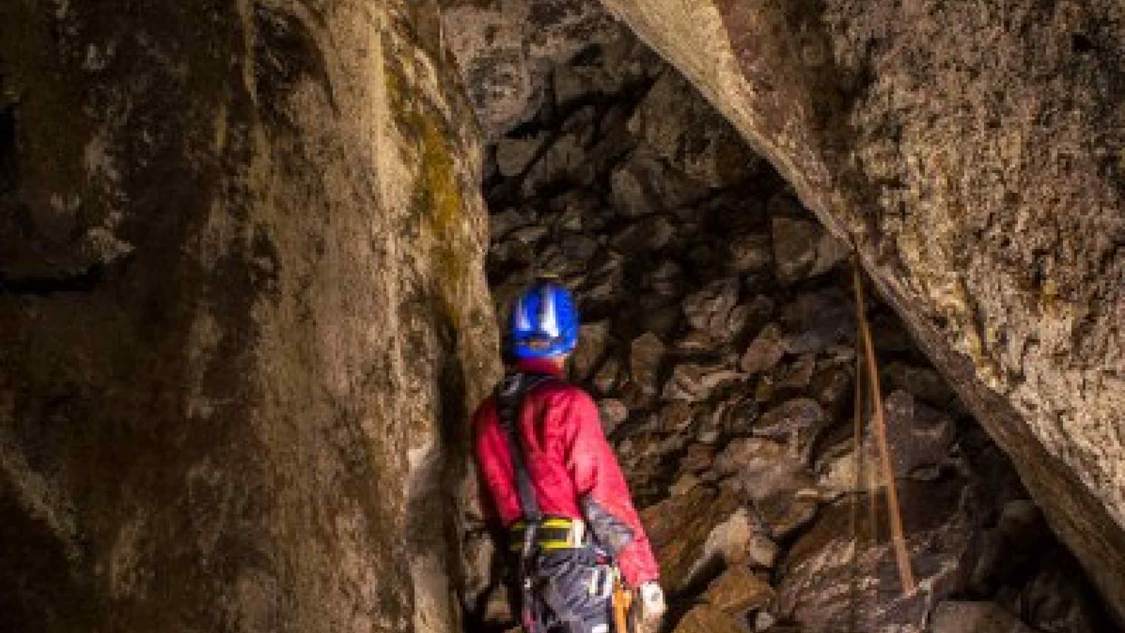 Underground mine trip and adventures in Cornwall. Exploeres here examining a large underground stope in a Cornish mine.
