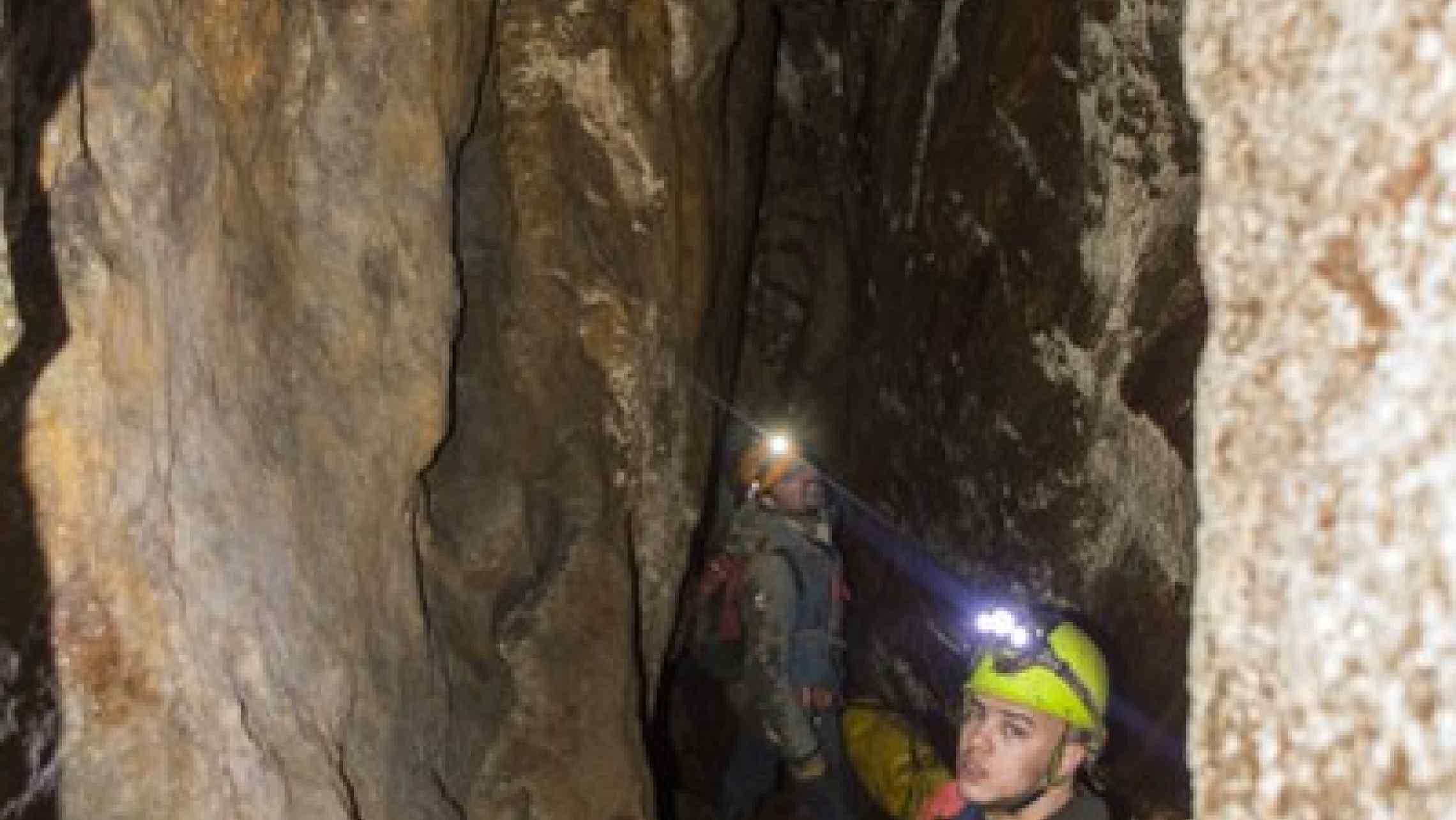 Mine explorers in a large stoped chamber in Cornwall. See these places for yourselves on a guided min adventure tour.