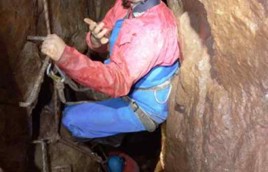 Descending a metal ladder deep in a Cornish tin mine, near Penzance.