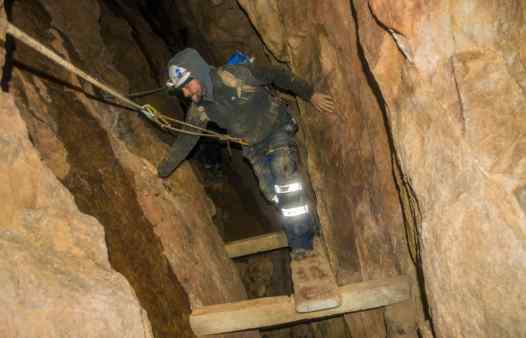 Mine explorer using ropes to cross deep mine shafts. Top adventure in a Cornish tin mine. Mine tours available across Cornwall, near St. Just, St. Ives, Penzance, Newquay, Falmouth and Helston.