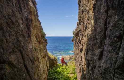 Cornwall Underground Adventure guide exploring an open stope in a Cornish cliff