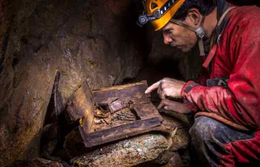 Underground artefacts in a Cornish tin mine. Mine explorer examines a box of fuses near St. Just