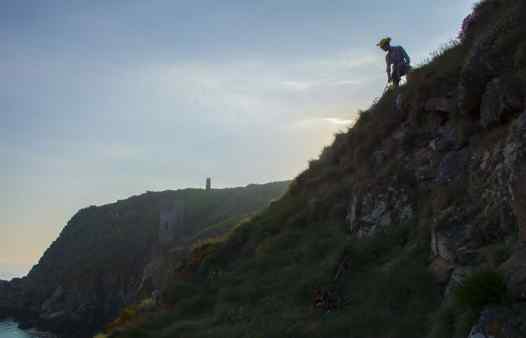 Cornwall Underground Adventures guide on the cliffs, searching for mine history and mining archaeology.