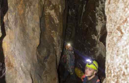 Mine explorers in a large stoped chamber in Cornwall. See these places for yourselves on a guided min adventure tour.